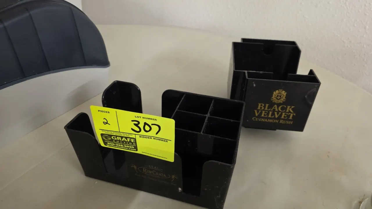 Plastic bar caddies and condiment organizers. Includes (2) black plastic tabletop organizers: (1) multi-compartment bar caddy with RumChata branding a