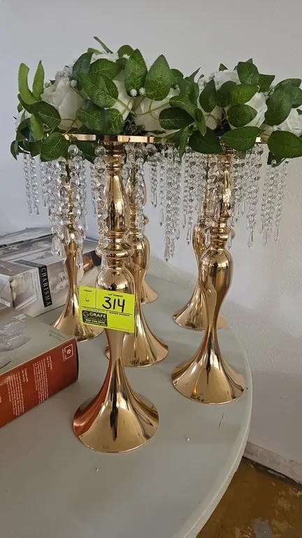Gold-tone metal flower stands. Features polished gold-tone finish, hanging faceted crystal-style bead strands, and round flared pedestal bases. Includ