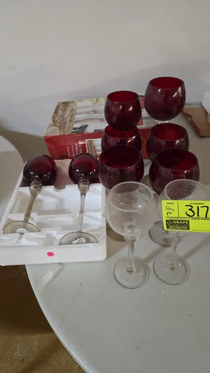 Assorted glass stemmed candle holders. Includes (8) red glass and (2) clear crackle glass goblet-style candle holders in varied heights. Includes part