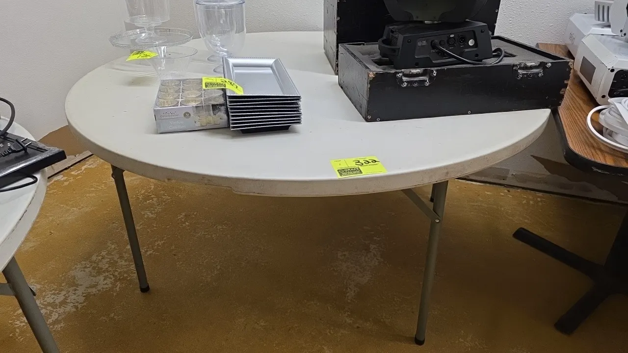 Round polyethylene folding table. Features a molded plastic top and folding metal legs. 60"Dia. Contents not included.