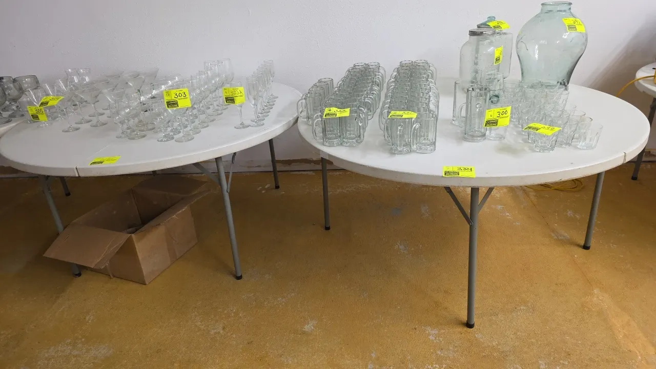 Round poly folding tables. Features white molded plastic tops and folding metal legs. 60"Dia. Contents not included.
