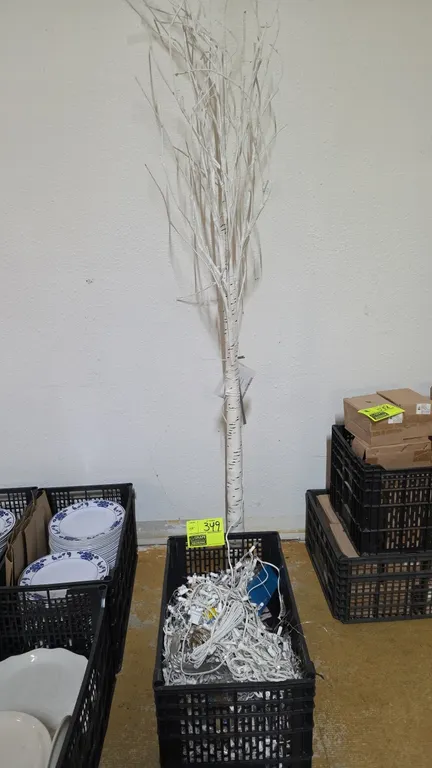 Decorative lighted birch tree and plastic crate with string lights. Includes faux birch lighted tree mounted on a square base plate and a black plasti