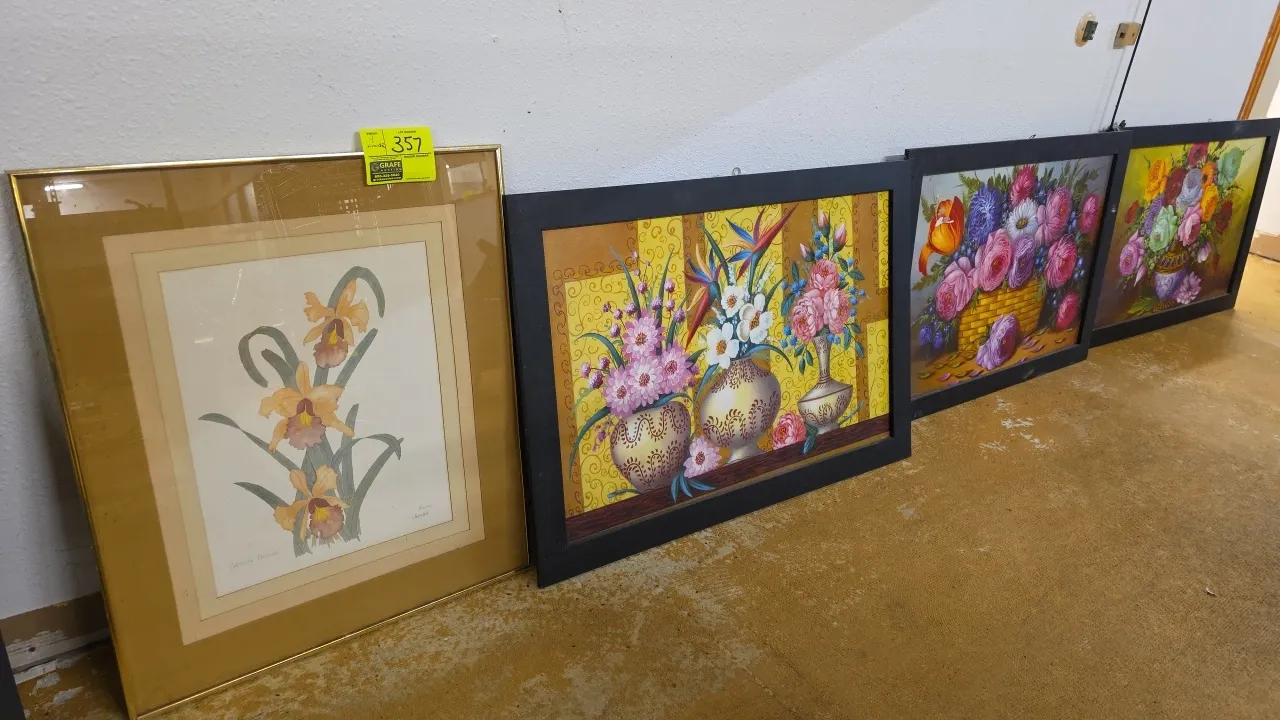 Assorted framed floral wall art. Includes (1) botanical orchid print in a gold-tone metal frame with double matting and (3) floral still-life prints i