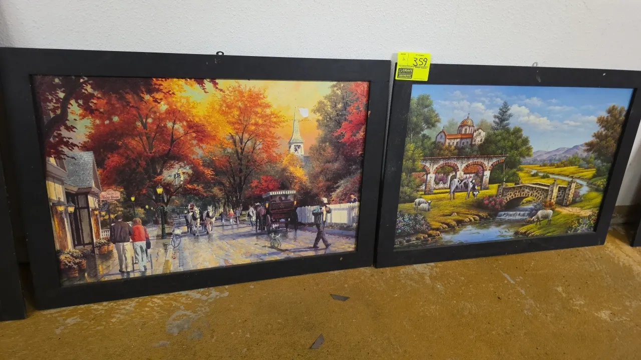 Framed wall decor prints. Features black frames depicting scenic landscape art, including an autumn street scene and a pastoral countryside scene with