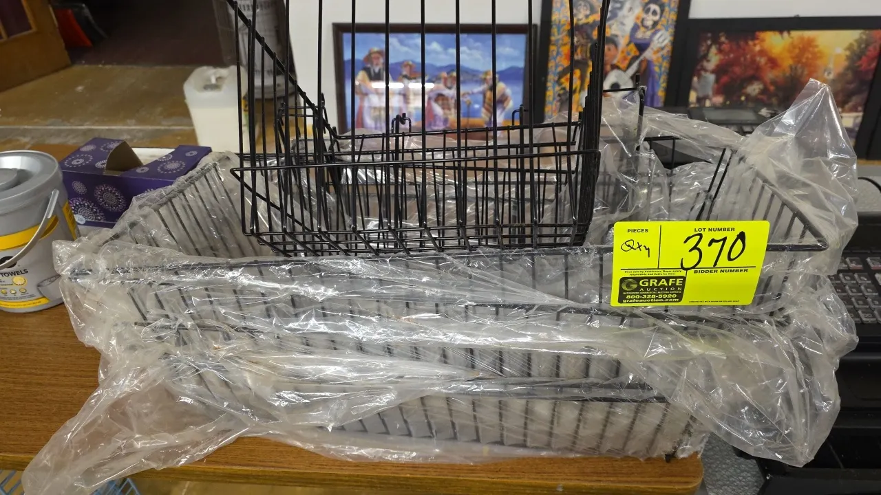 Black wire display baskets. Features coated wire construction with integrated mounting brackets for pegboard or slatwall displays. Includes four baske
