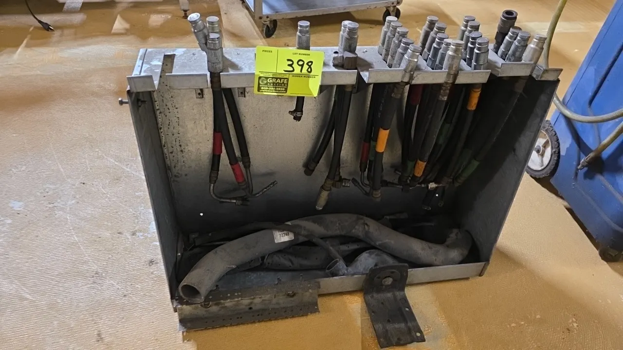 Galvanized metal wall-mounted hose rack. Includes assorted hoses with quick-connect fittings. 28" x 20".