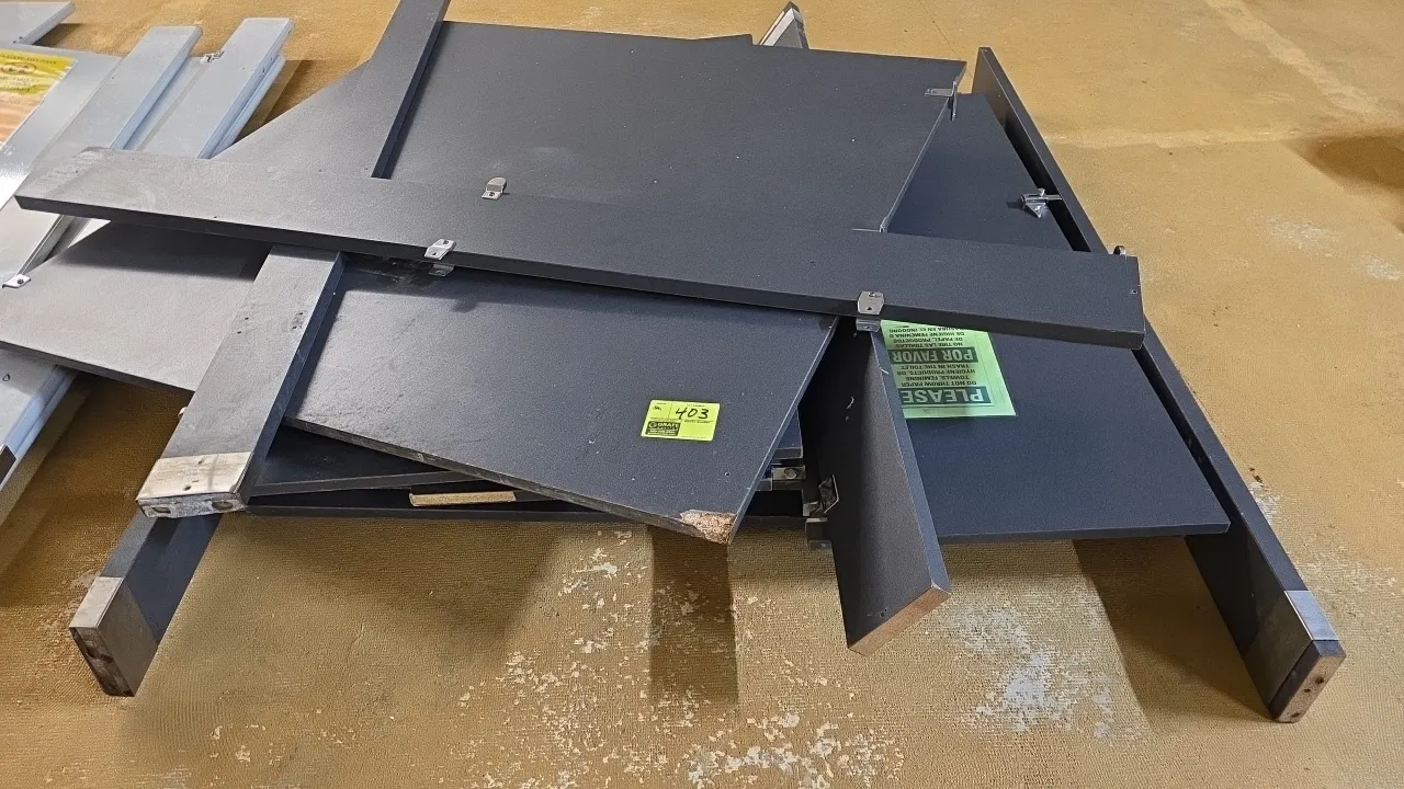 Laminated restroom stall partition components. Includes divider panels, pilasters, and attached hardware brackets with stainless steel base shoes. Dar