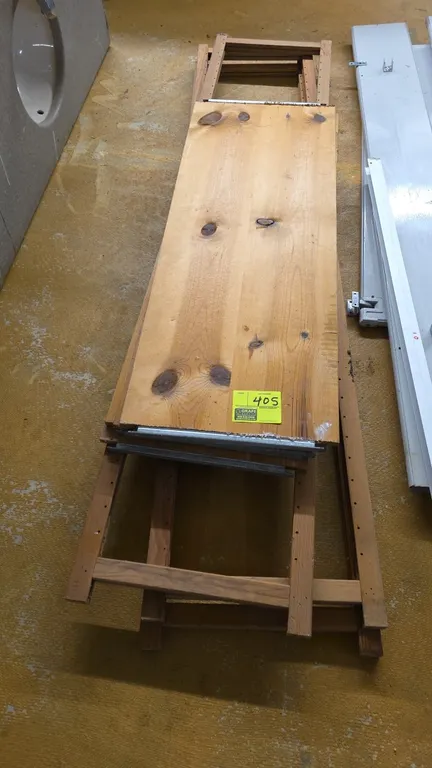 Wood shelving unit. Features solid wood construction, ladder-style upright frames, and wooden shelf boards with metal channel edges. Disassembled. Dim
