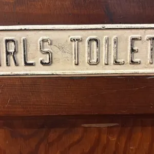 Vintage metal girls bathroom sign