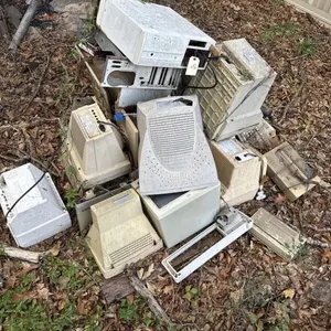 Scrap pile of computer monitors and parts.