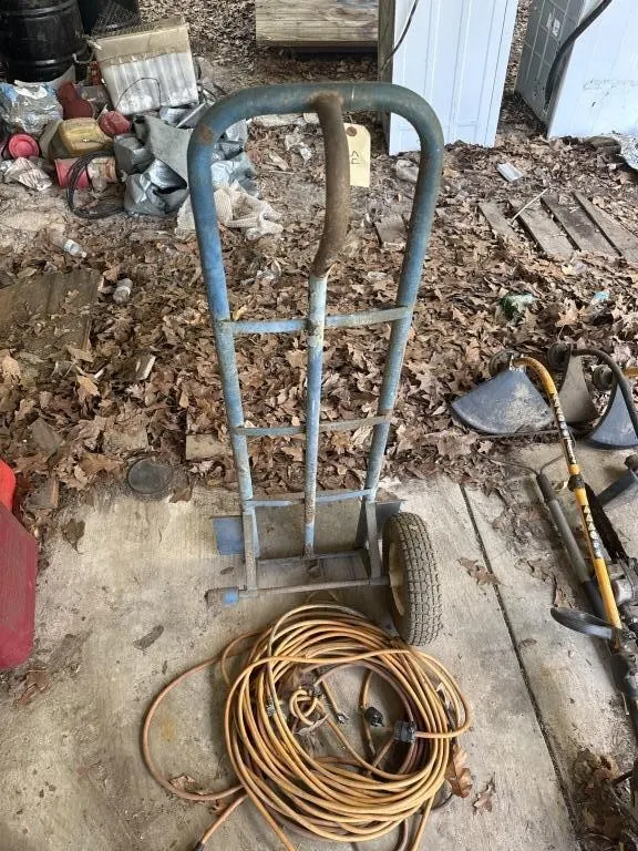 Dolly with wheel missing. Two extension cords.