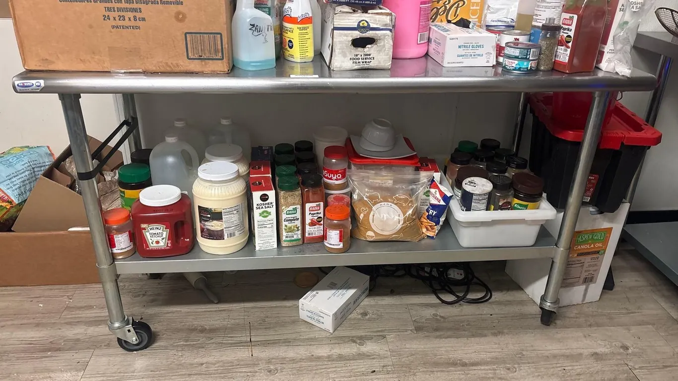 STAINLESS STEEL TABLE ON CASTERS with lower shelf