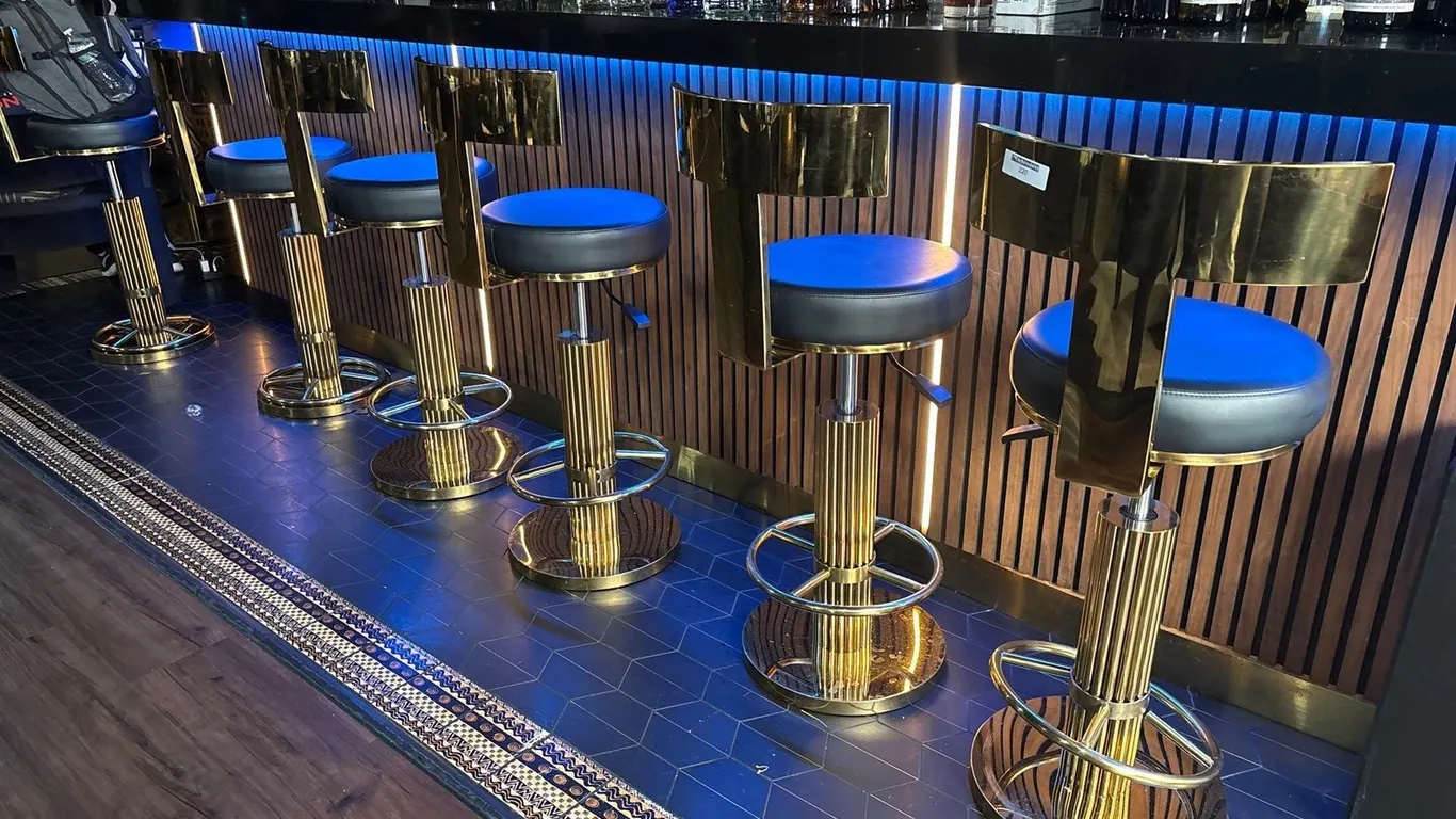 (6) GOLDEN MIDBACK BAR STOOLS WITH BLACK LEATHERETTE UPHOLSTERY
