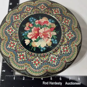 Round Dutch decorative tin box with an intricate floral lid