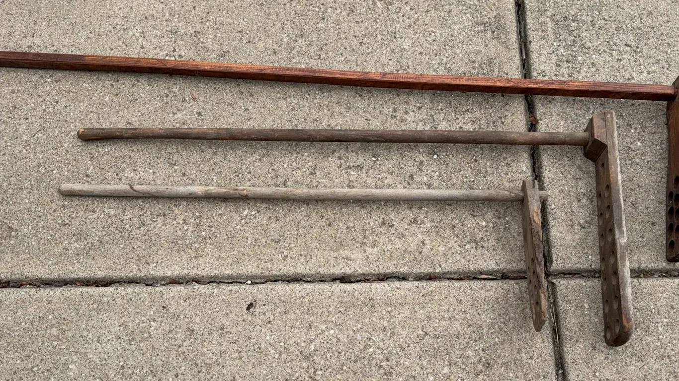 3 antique wooden objects are laundry dashers (also known as agitators)