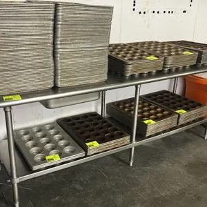 Stainless steel work table. Features a stainless steel undershelf. 96" x 30". Mounted on (6) tubular legs with adjustable bullet feet. Contents not in