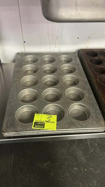 15-cup metal muffin pans. Features commercial metal construction with a 3 x 5 cavity layout per pan.