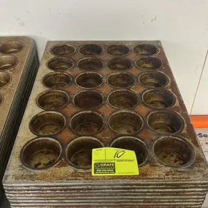 24-cup metal muffin pans. Features commercial metal construction with 24 individual baking cups arranged in a 4 x 6 layout and reinforced rims.