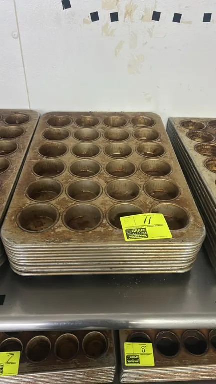 24-cup metal muffin pans. Commercial baking pans feature a 4 x 6 layout with 24 cups per pan and rolled rims.