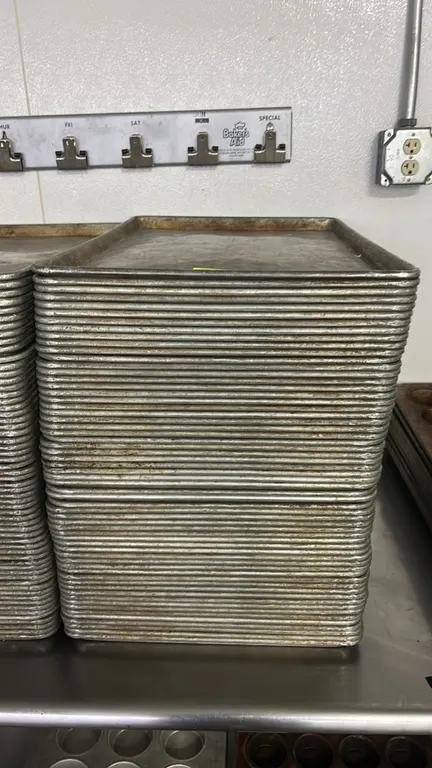 Metal full-size sheet pans. Commercial baking pans featuring wire-reinforced beaded rims.