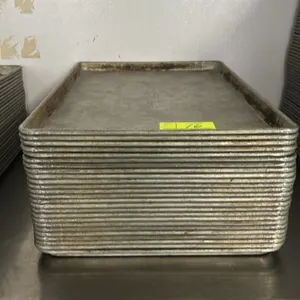 Metal full-size sheet pans. Features wire-reinforced rolled rims and nesting design. Stainless steel table and accessories not included.