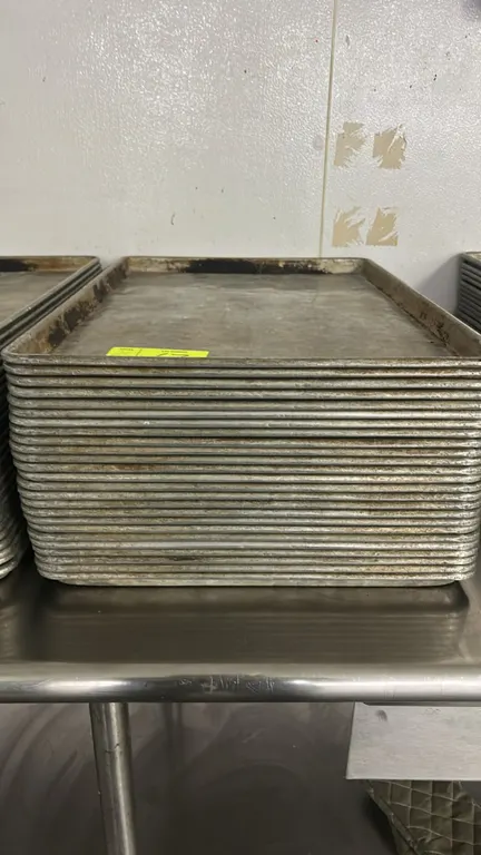 Metal full-size sheet pans. Features wire-reinforced rolled rims. Stainless steel table not included.