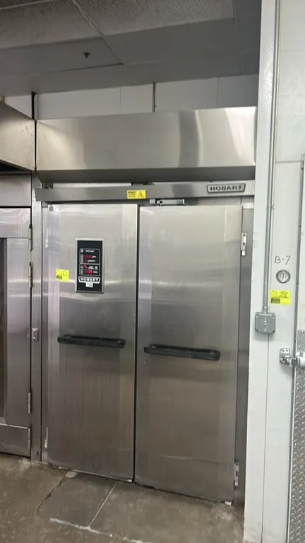Hobart HP2 stainless steel 2-door roll-in proofer. Features digital controls for temperature, humidity, and timers, dual full-height doors, and interi