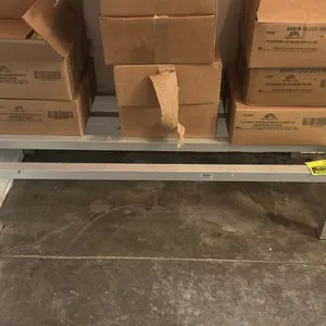 Metal dunnage rack. Features welded tubular construction with a slatted top. 48"L x 20"W. Contents not included.