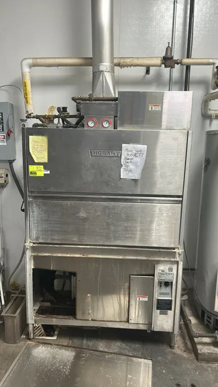 Hobart UW50 stainless steel commercial utensil and pan washer. Features drop-down door, interior wire rack, and top-mounted gauges. S/N: 85-1078504. E