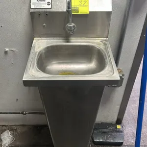 Krowne HS-14 stainless steel pedestal handwashing sink. Features a gooseneck faucet, integrated backsplash, and dual foot pedal controls. Mounted on a