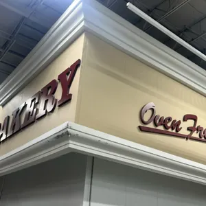 Quantity of walk-in panels with decorative facade and signage. Features white insulated wall panels, upper facade trim with crown molding, and dimensi