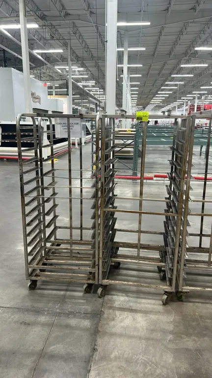 Aluminum full-size side-load oven racks. Features aluminum tubular construction with multi-tier angle slides for sheet pans. Mounted on swivel casters