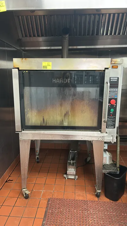 Hardt Inferno 4500 commercial natural gas rotisserie oven. Features stainless steel construction, 8-spit, 40-chicken capacity, digital programmable co