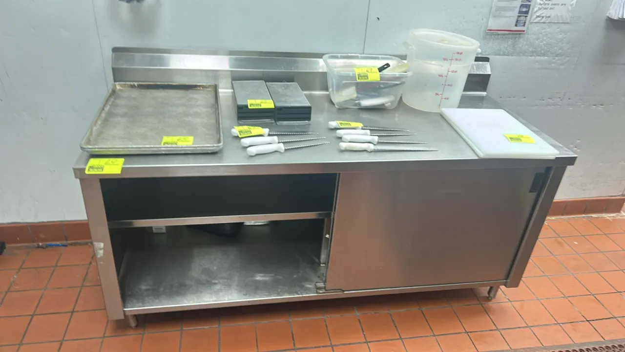 Win-Holt stainless steel enclosed base prep table. Features a rear backsplash, interior intermediate shelf, and single sliding door. 72"L x 30"W. Moun