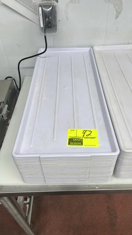 Poly display trays. Features white molded plastic construction with ribbed bottoms and stackable design. Dimensions: 30" x 13".