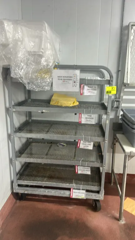 Metal multi-tier utility cart. Features 5 expanded metal mesh shelves and tubular frame construction. 44" x 26". Mounted on casters. Contents not incl