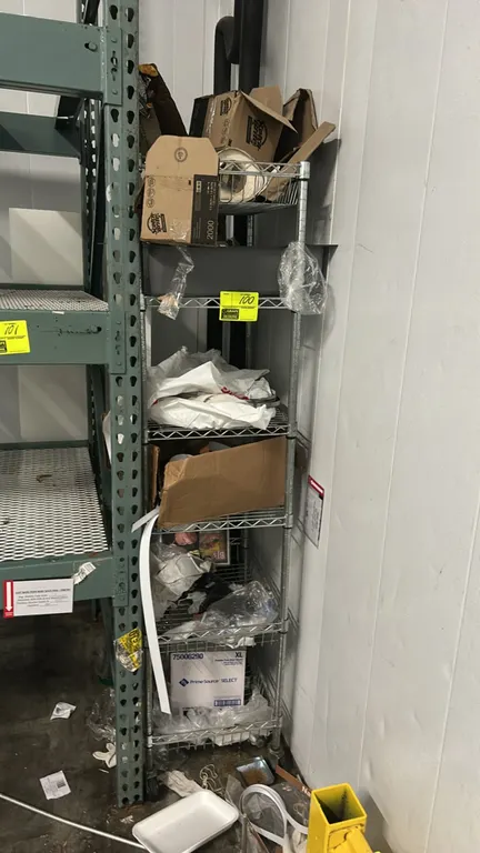 Multi-tier metal wire rack. Features wire construction with multiple tiers and includes quantity of dry goods and supplies as shown. 24" x 18". Mounte