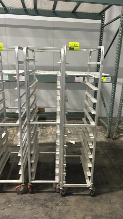Aluminum full-size front-load channel pan racks. Features aluminum construction with angle slide channels. Mounted on swivel casters. Pallet racking i