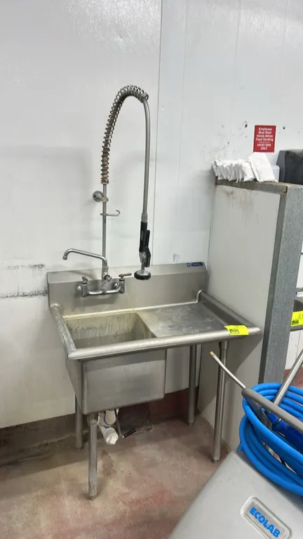 Amtekco stainless steel single-compartment sink. Features right drainboard, integrated backsplash, splash-mount pre-rinse faucet assembly with swing s
