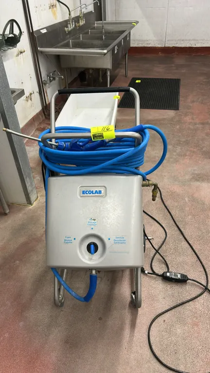Ecolab mobile foam, rinse, and sanitization unit. Features foam, rinse, and sanitize selector dial, hose wrap handle, coiled blue hose with spray wand
