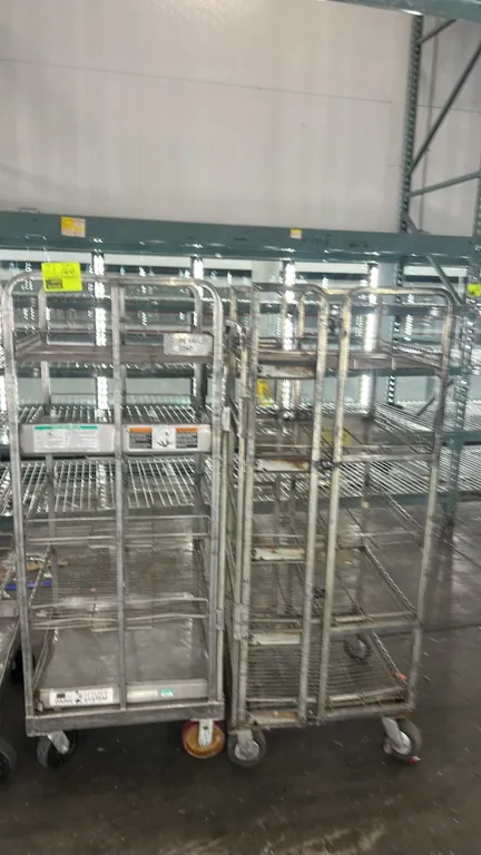 Metal wire multi-tier portable racks. Features multi-tier wire shelving and tubular metal frame construction. 26" x 26". Mounted on swivel casters.
