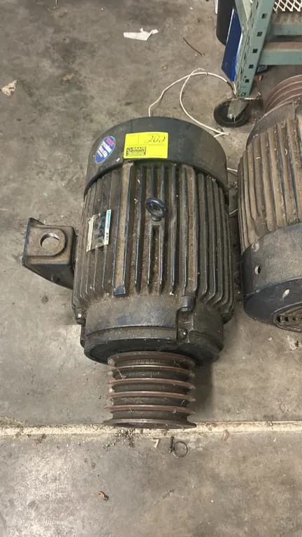 Marathon Electric XRI industrial AC motor. Features cast iron housing, lifting eyebolt, TEFC enclosure, and 5-groove belt pulley. Rigid base mount. 17