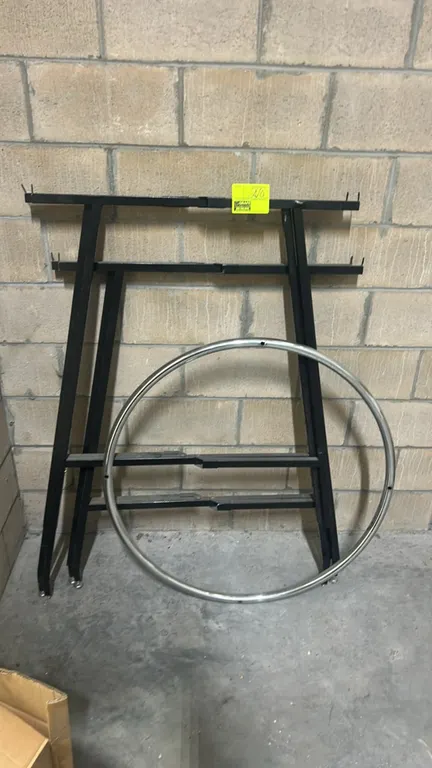 36" round folding garment rack. Features a chrome circular hang rail and black metal folding frame with leveling feet.