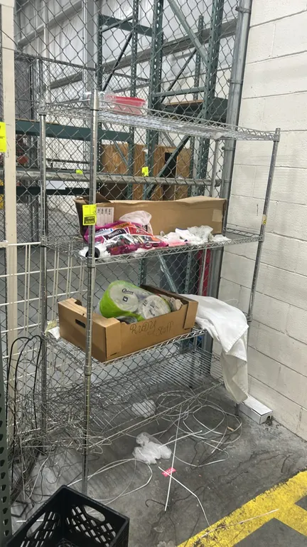 Stainless steel wire multi-tier rack. Features 4 adjustable wire shelves and 4 corner posts. 48" x 18". Contents not included.