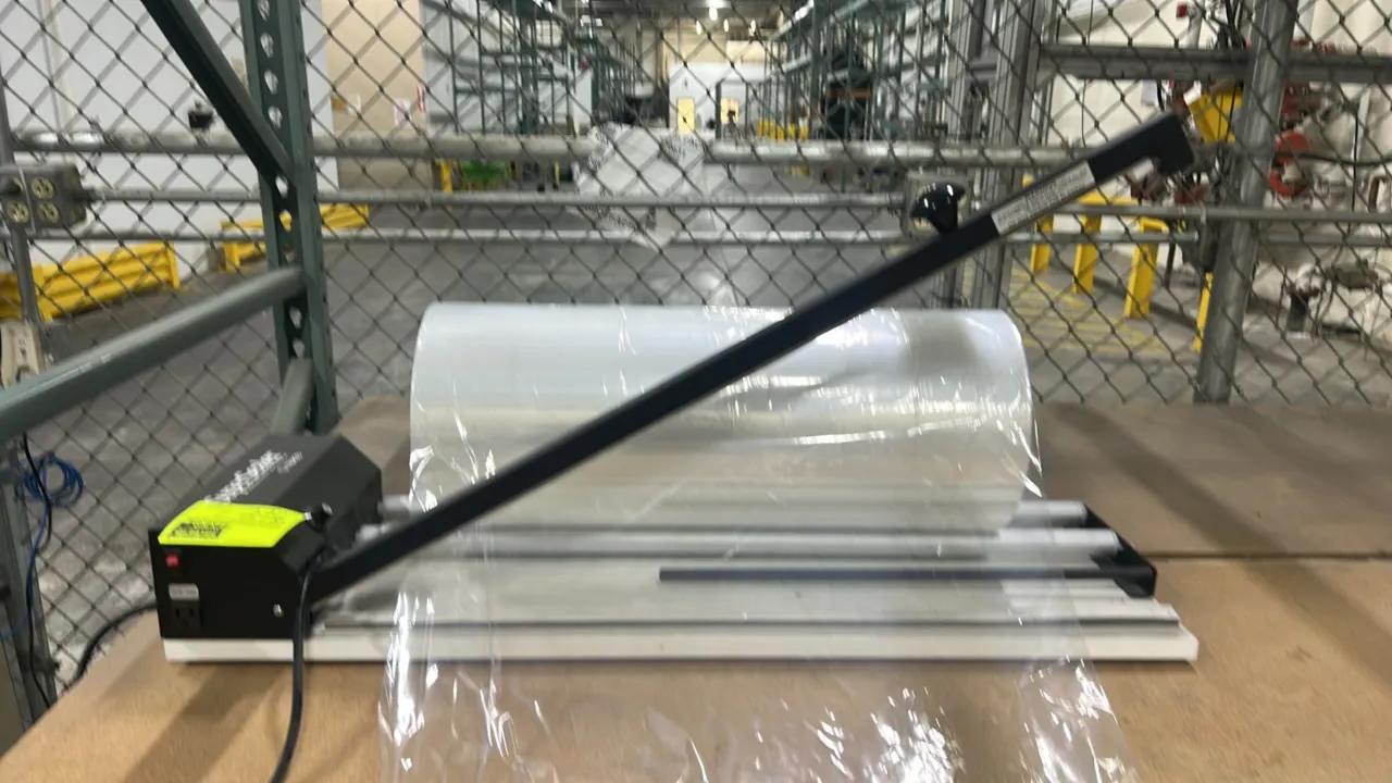 Traco SuperSealer SS-32DS shrink wrap system. Features sealing wand, dual-roller film cradle with shrink wrap film roll, and variable heat control dia