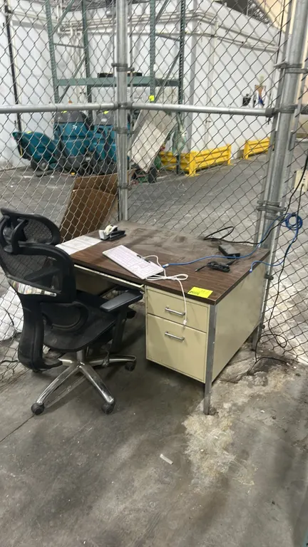 Laminate office desk and mesh task chair. Desk features a faux woodgrain laminate top, metal frame, 2-drawer pedestal, and center slide drawer. 45" x