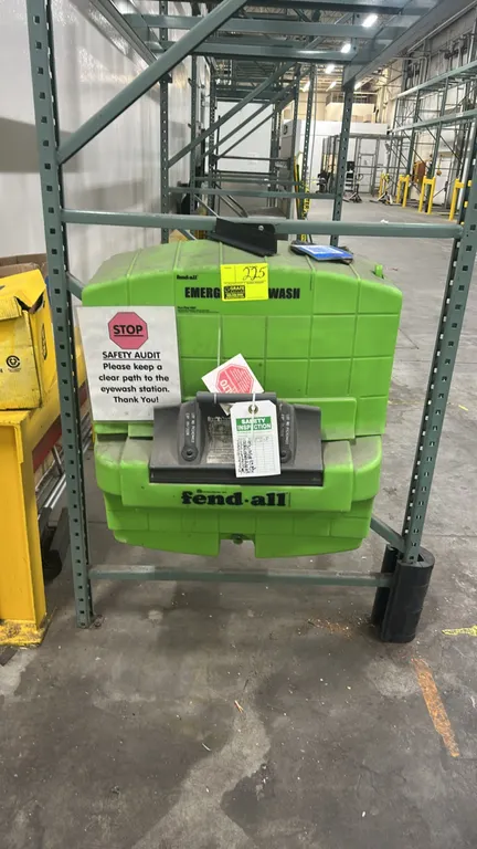 Honeywell Fendall Pure Flow 1000 portable emergency eyewash station. Features high-visibility green molded plastic housing, pull-down activation handl