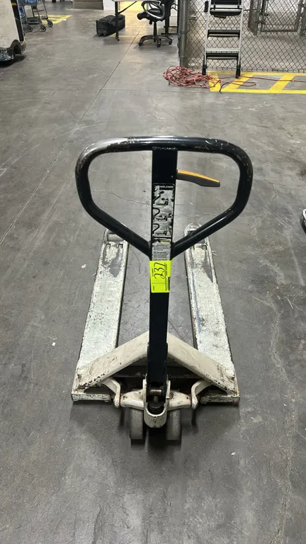 Crown manual pallet jack. Features steel construction, manual hydraulic lift operation, loop steering handle with release lever, dual front steer whee