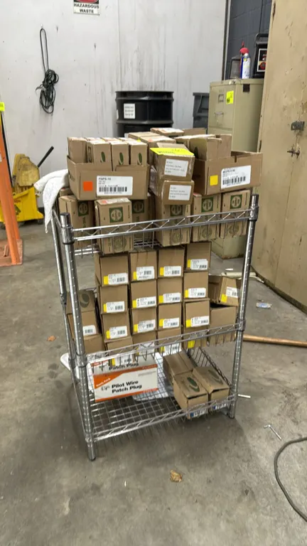 Metal 3-tier wire rack with assorted wheel weights. Features chrome wire construction with three shelves. Includes assorted boxed clip-on and adhesive
