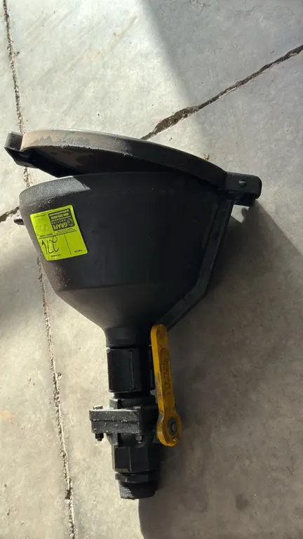 Poly drum funnel. Features hinged lid, integrated ball valve with yellow lever handle, and threaded base fitting. Black polyethylene construction.